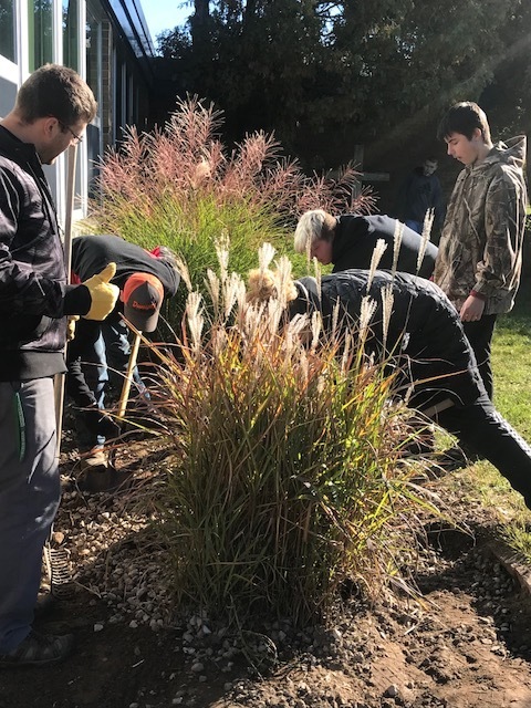 Ecology students prepare grounds for school garden. 